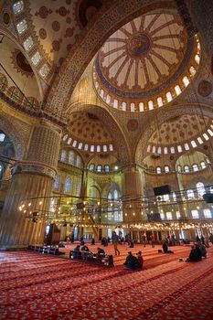 Istanbul, Turkey - 1 April, 2017: Interior of blue Mosque also called Sultan Ahmed Mosque or Sultan Ahmet Mosque in Istanbul, Turkey.Ceiling decorations with Islamic elements of Sultan Ahmed Mosque dome