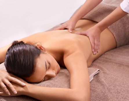 Shot of a beautiful young woman enjoying a relaxing massage.