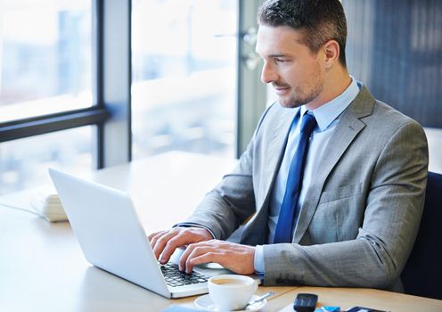 Shot of a businessman working on a laptop in the office.