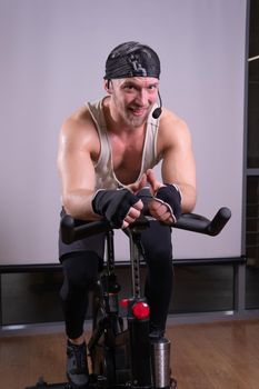 Bicycle athlete a bike on pumped trainer up legs training gym fit, from young fitness in body and weight sportswear, ay man. Young lothing adult, pedal fat caucasian strong woman cycling