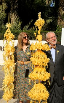 Elche, Alicante, Spain- April 10, 2022: People with award winning white palms for the Palm Sunday of the Holy Week of Elche