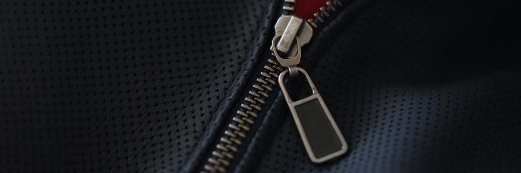 Closeup of steel zipper on leather jacket. Zipper replacement services concept