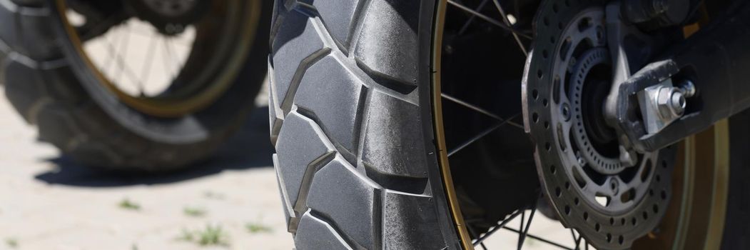 Closeup of scooter wheel in parking lot. Vehicle rental concept