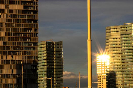 Some tall buildings in Barcelona and the sun reflection on one of them