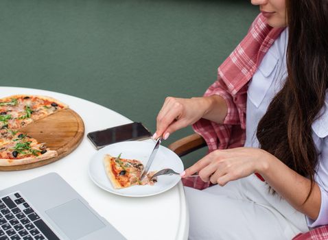 Top view of business woman working on a table at a pizza restaurant