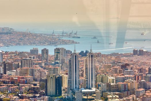 Urban landscape of European side of Istanbul and Bosphorus Strait on a horizon. Modern part of city with business towers of international corporations, skyscrapers and shopping malls of the city. Shooting through the glass. Retro style