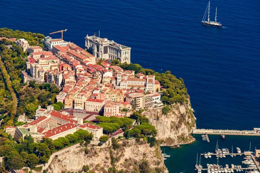Aerial view of port Fontvieille at sunset, Oceanographic Museum of Monaco, South France, a lot of boats are moored in marina, view of city life from La Turbie mountain, mega yachts, luxury apartments. High quality photo