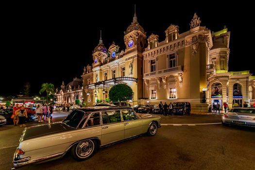 Monaco, Monte Carlo, 21 August 2019: Vintage Mercedes Benz car near the hotel Paris and casino in night, lights of the place Casino. High quality photo
