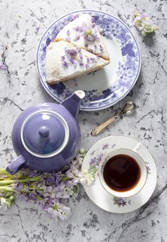 still life with black tea and cheese cake, spring bouquet of delicate lilac flowers, flatley food, High quality photo