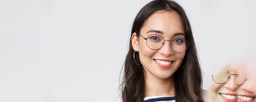 Business, finance and employment, female successful entrepreneurs concept. Face of smiling asian businesswoman, working in office, wearing glasses and gazing camera confident.