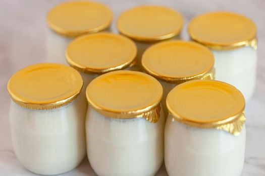 natural whole milk industrial yogurt in glass pots without expiration date