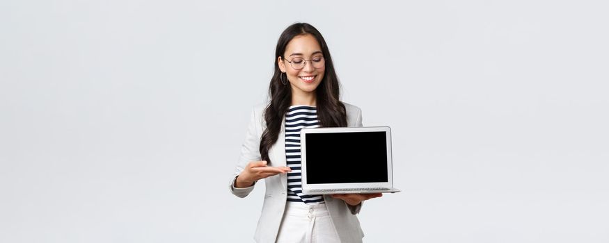 Business, finance and employment, female successful entrepreneurs concept. Professional businesswoman, real estate broker pointing finger at laptop screen, showing good deal, having meeting.