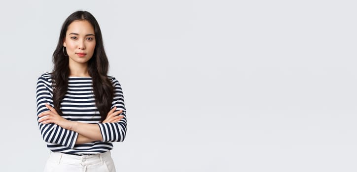 Lifestyle, people emotions and casual concept. Confident nice smiling asian woman cross arms chest confident, ready to help, listening to coworkers, taking part conversation.