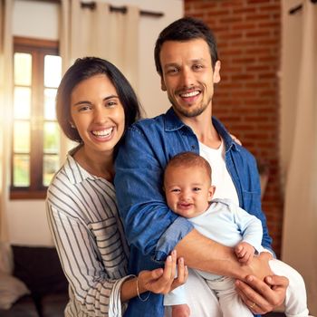 Cropped portrait of an affectionate young couple and their baby boy at home.
