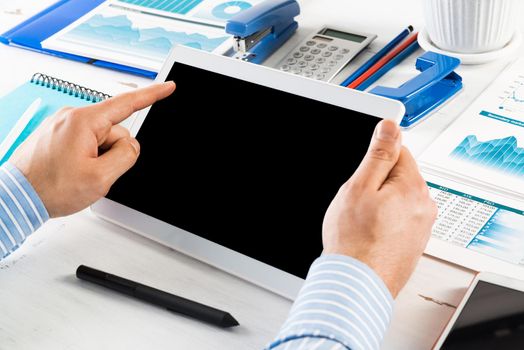 close-up of men's hands with a computer tablet. Businessman works in the office