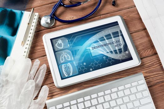 White tablet pc and doctor tools on wooden table