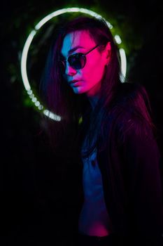 Portrait of asian man wearing sunglasses in neon light
