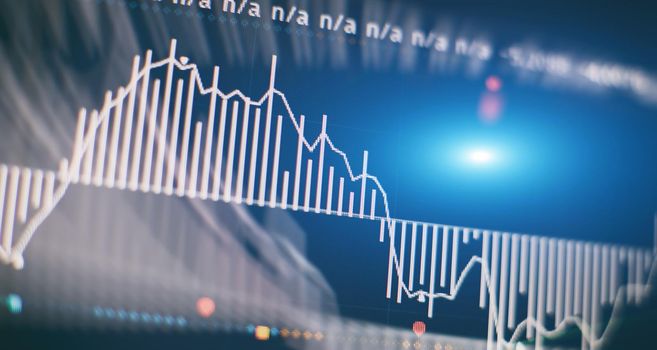 Abstract financial graph with candle stick and bar chart of stock market on financialbackground