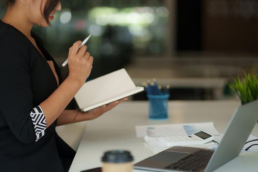Beautiful Asian Business woman watching educational webinar on laptop computer. Finance concept