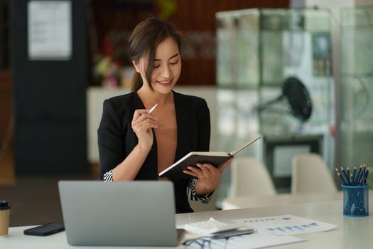 Beautiful Asian Business woman watching educational webinar on laptop computer. Finance concept