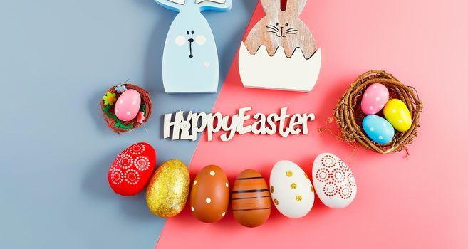 Happy Easter holiday background concept.Flat lay colorful bunny eggs  on modern beautiful grey-pink paper at office desk.
