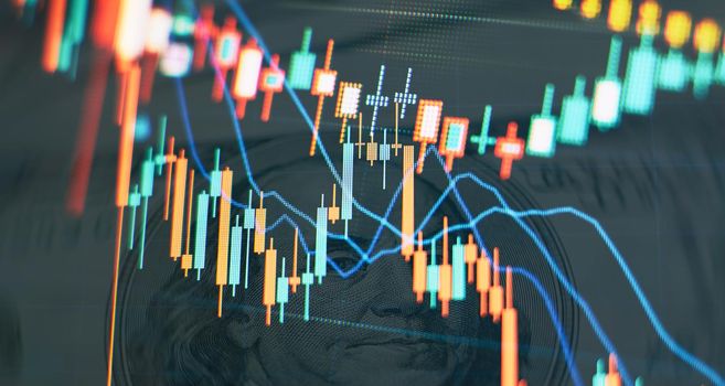 Charts of financial instruments with various type of indicators including volume analysis for professional technical analysis on the monitor of a computer.