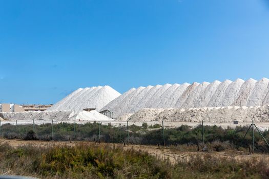 Burning white salt in the warehouse. This is how table and sea salt is produced and stored on the shore of the salt lake.