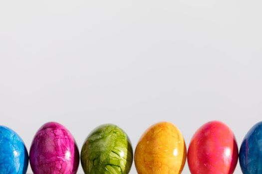 Lined up colored eggs as a decoration for Easter. Old Polish tradition of decorating and painting eggs.