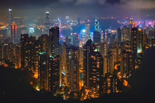 Famous view of Hong Kong - Hong Kong skyscrapers skyline cityscape view from Victoria Peak illuminated in the evening blue hour. Hong Kong, China