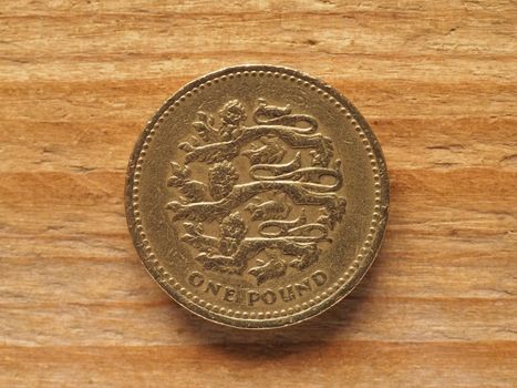 one pound coin reverse side showing three lions passant guardant representing England, currency of the United Kingdom