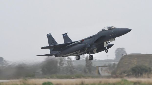 Andravida Greece APRIL, 1, 2022 McDonnell Douglas Boeing F-15E Strike Eagle American all-weather multirole strike fighter jet of United States Air Force in Europe USAFE take-off
