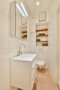 Bathroom interior with ceramic sink and toilet surrounded by white tiles