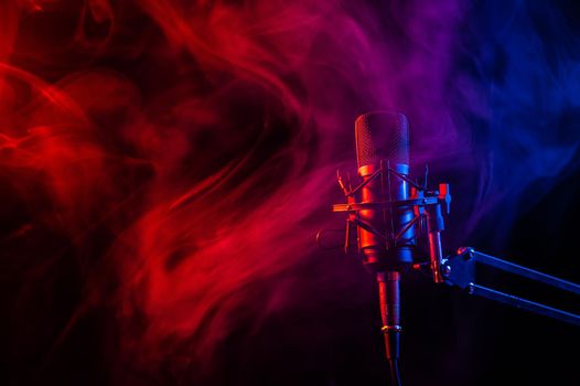 Professional microphone in pink smoke on a black background