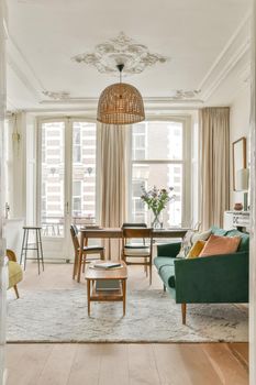 The rich interior of the living room of a modern house combined with a dining area