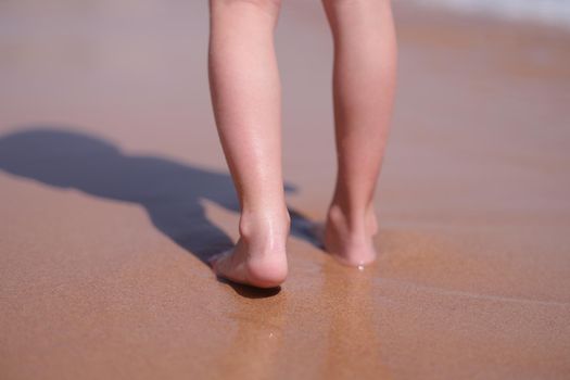 Wet bare feet walk along beach along sea. Keep calm on vacation and being alone concept