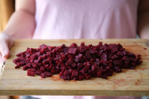 Fresh homemade sliced beets on cutting board. Natural ingredients for preparing vegan food.