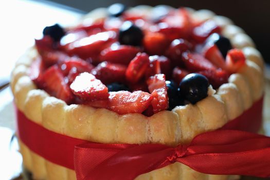 Delicious floury sweet cake with strawberries and currants. Cooking cake at home concept