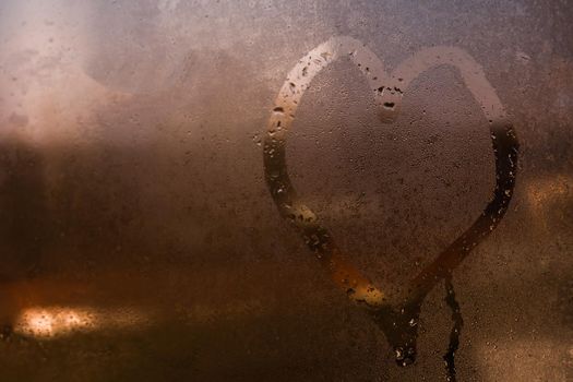 Painted heart on the foggy window. I love you on Valentine's Day