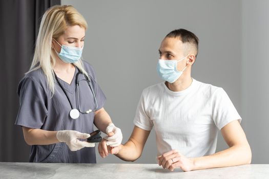 the coronavirus epidemic. Doctor checking oxygenation with fingertip pulse oximeter. Saturation blood of oxygen.