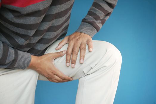 young man suffering pain on muscle on feet .