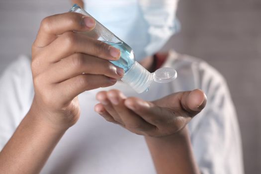 close up of young man hand using sanitizer gel for preventing virus.