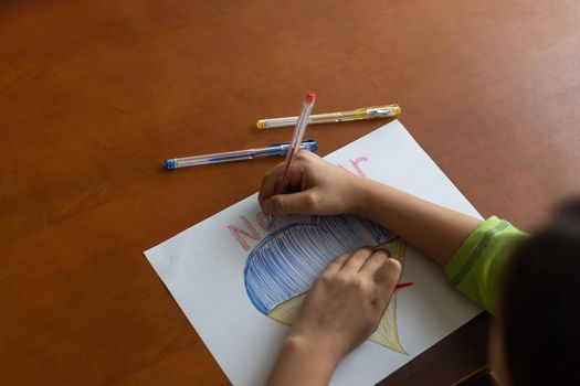 Ukrainian flag and a heart in yellow and blue color. Child draws a heart on the blackboard.