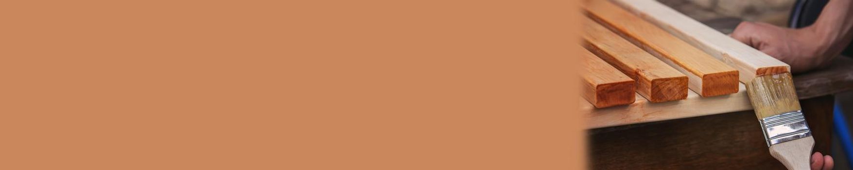 Painting wooden furniture with varnish. a man hides a tree with varnish. Selective focus
