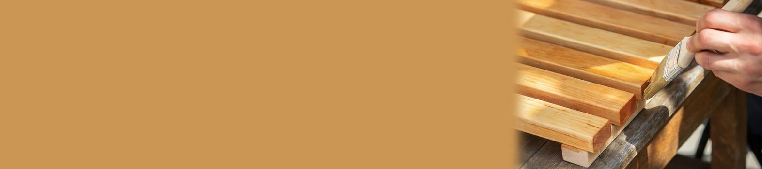 Painting wooden furniture with varnish. a man hides a tree with varnish. Selective focus