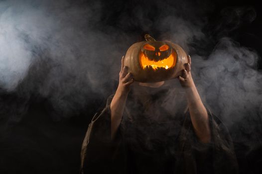 Pumpkin jack o lantern instead of a woman's head. Halloween.