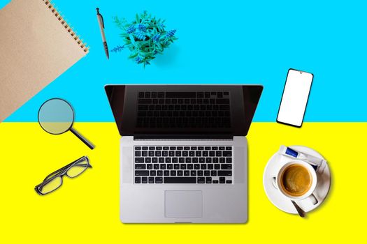 Visit Ukraine concept for your web banner or print materials. Top view of a laptop, coffee cup on Ukraine national flag. Flat style travel planninng website header