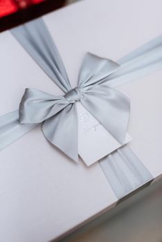 gifts in the hands of a girl in white boxes with ribbons