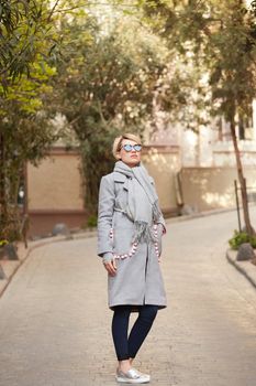 Young blond woman with sunglases on the street.