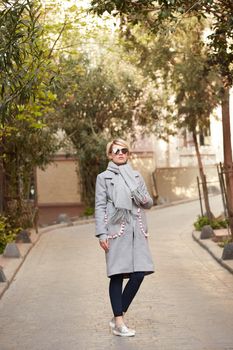 Young blond woman with sunglases on the street.