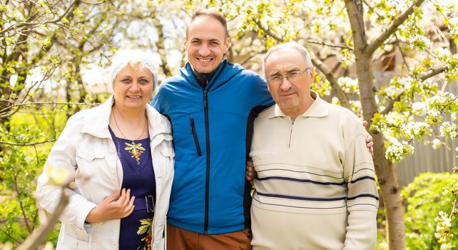 Portrait Of Family With Adult Son outdoors